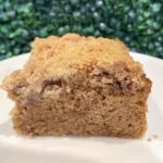 Gluten-free vegan cinnamon coffee cake slice with crumb topping