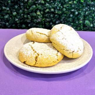 Yellow colored lemon sugar cookies on a white plate